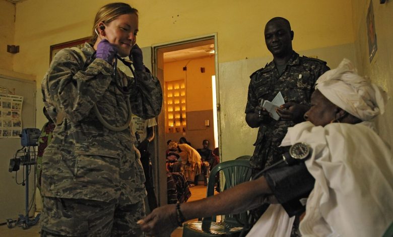 nurse taking a patient's blood pressure during a check