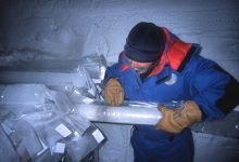 A scientist examining a drilled ice core sample
